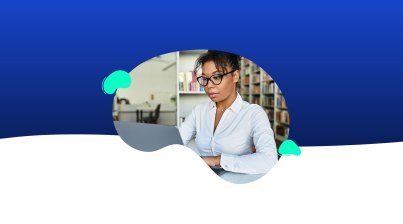 A woman wearing glasses and a white shirt works on a laptop in a library, preparing presentations, with a blue and white abstract background.