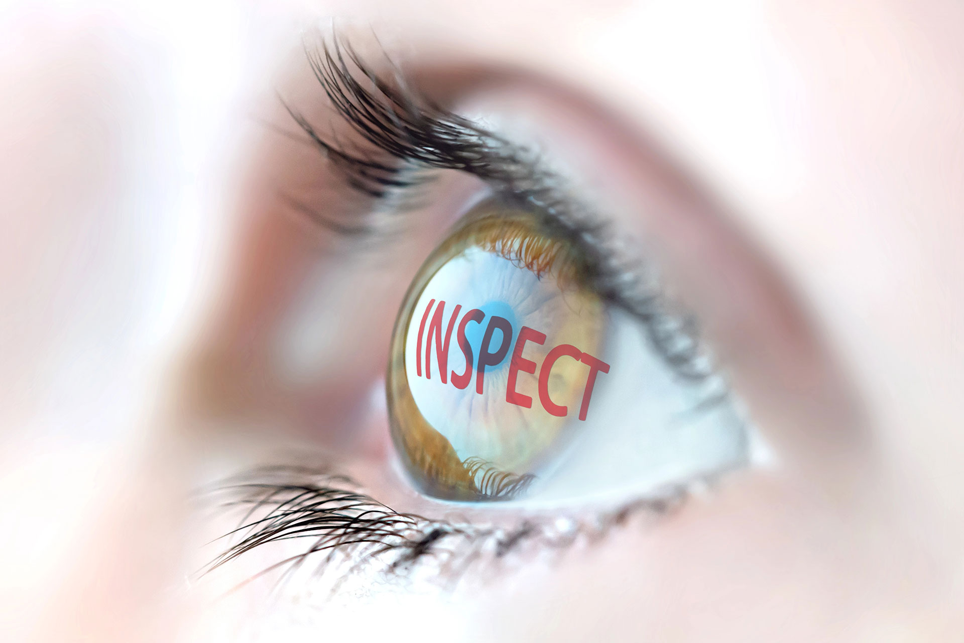 Close-up of a human eye with the word "INSPECT" reflected in the iris, symbolizing responsible AI adoption in universities.