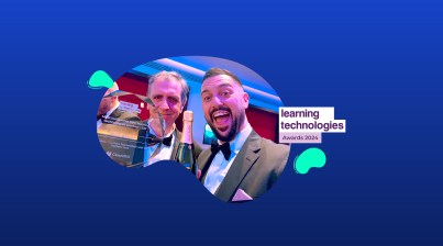 Two men in tuxedos, smiling and holding a trophy and champagne, stand before a "Learning Technologies Awards 2024" sign on a blue abstract background, celebrating innovations like TeacherMatic's role in transforming vocational education through the Blended Learning Consortium.
