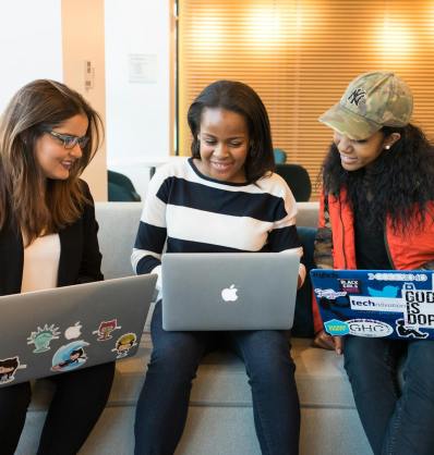 three woman in front of laptop computer