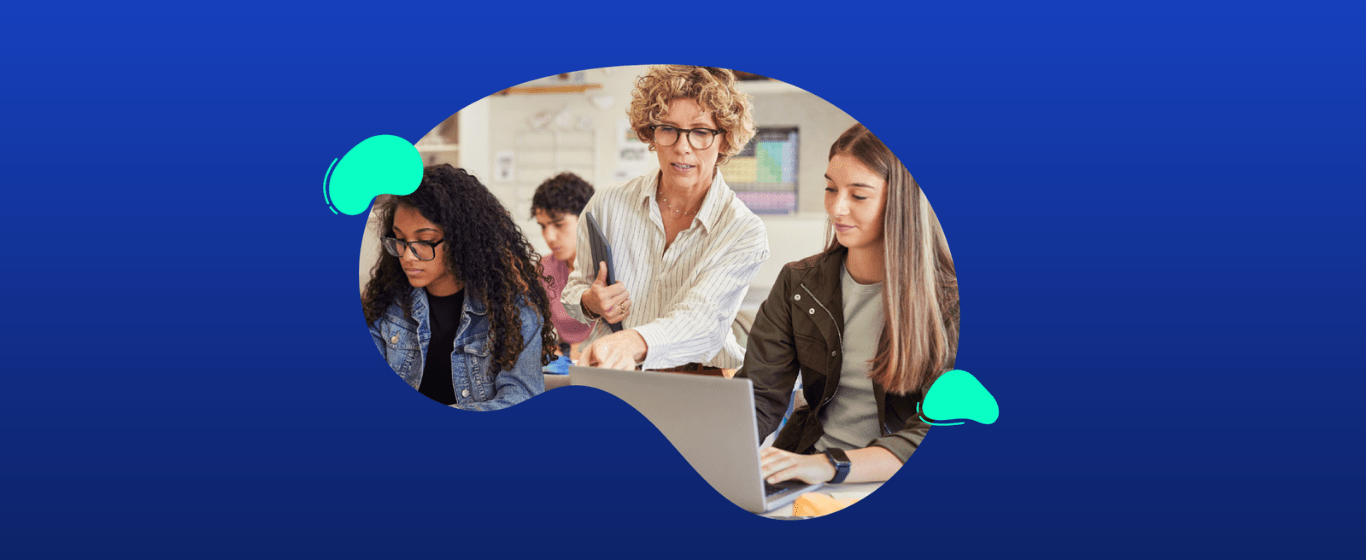 A teacher stands and gestures while assisting two students working on laptops in a classroom setting, with a blue abstract background.