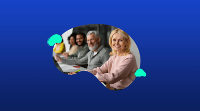 A group of adults sits at a table, smiling and looking forward, with a blue background and abstract shapes framing the photo—perfect for representing Universities, Colleges, and Schools.